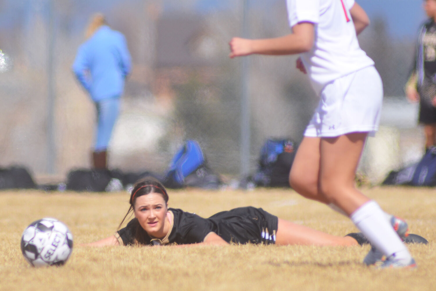 Margaret Olsen lays flat on the ground